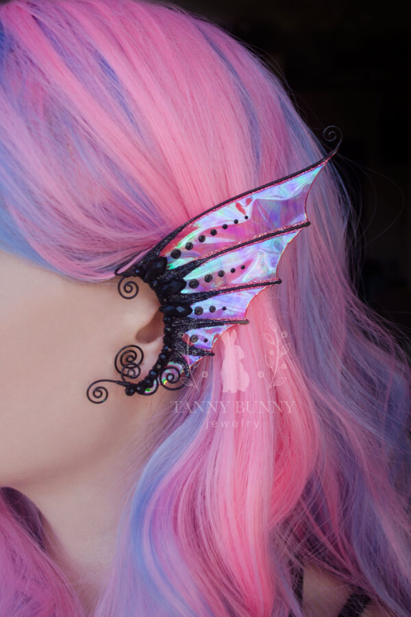 Model with pink hair wearing black handmade mermaid ear cuff