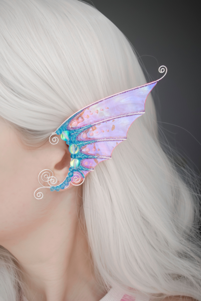 Mermaid ear cuff in pink and blue on model with white hair, handmade fantasy accessory