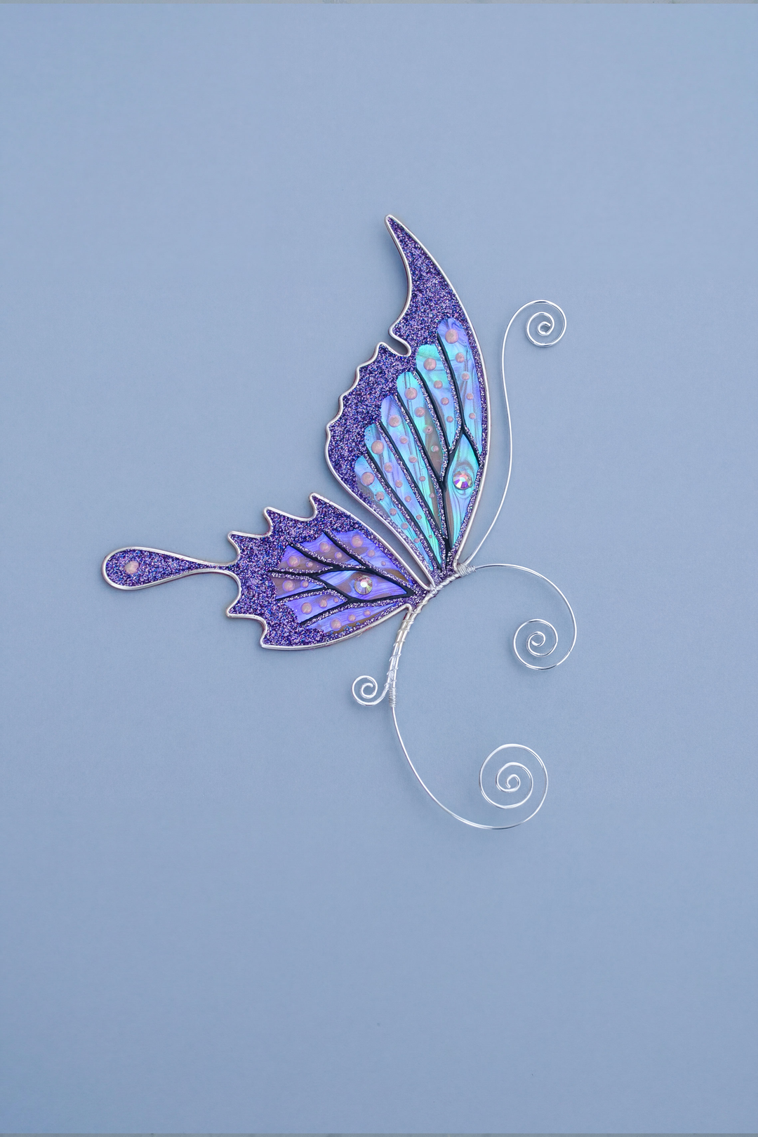 Purple butterfly ear cuff on blue background, handmade fairy wing earring, no piercing needed