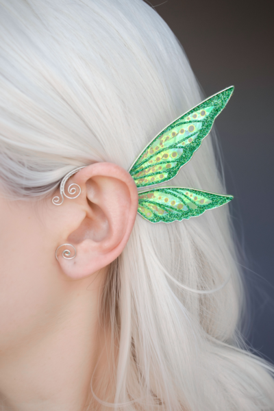 Fairy cosplay ear cuff, green, handmade, no piercing needed, fairy earring — green wing ear cuff worn on ear of model with white hair.