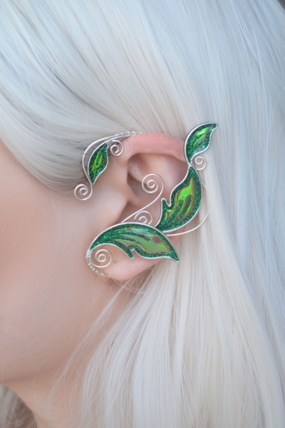 Emerald green handmade elven leaf ear cuff worn on white-haired model, no piercing needed