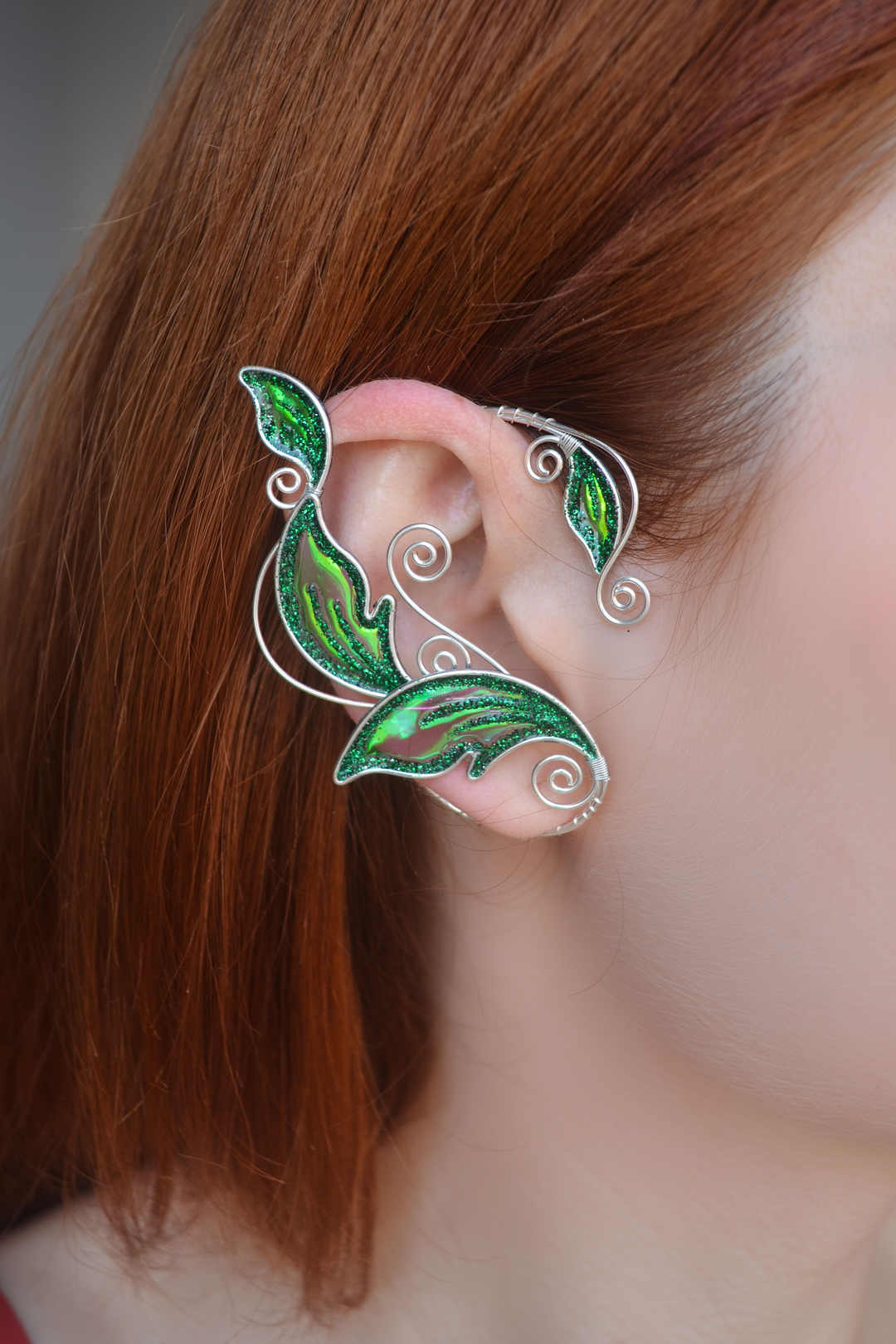 Emerald green elven leaf ear cuff worn on red-haired model, handmade no-piercing elf ear cuff