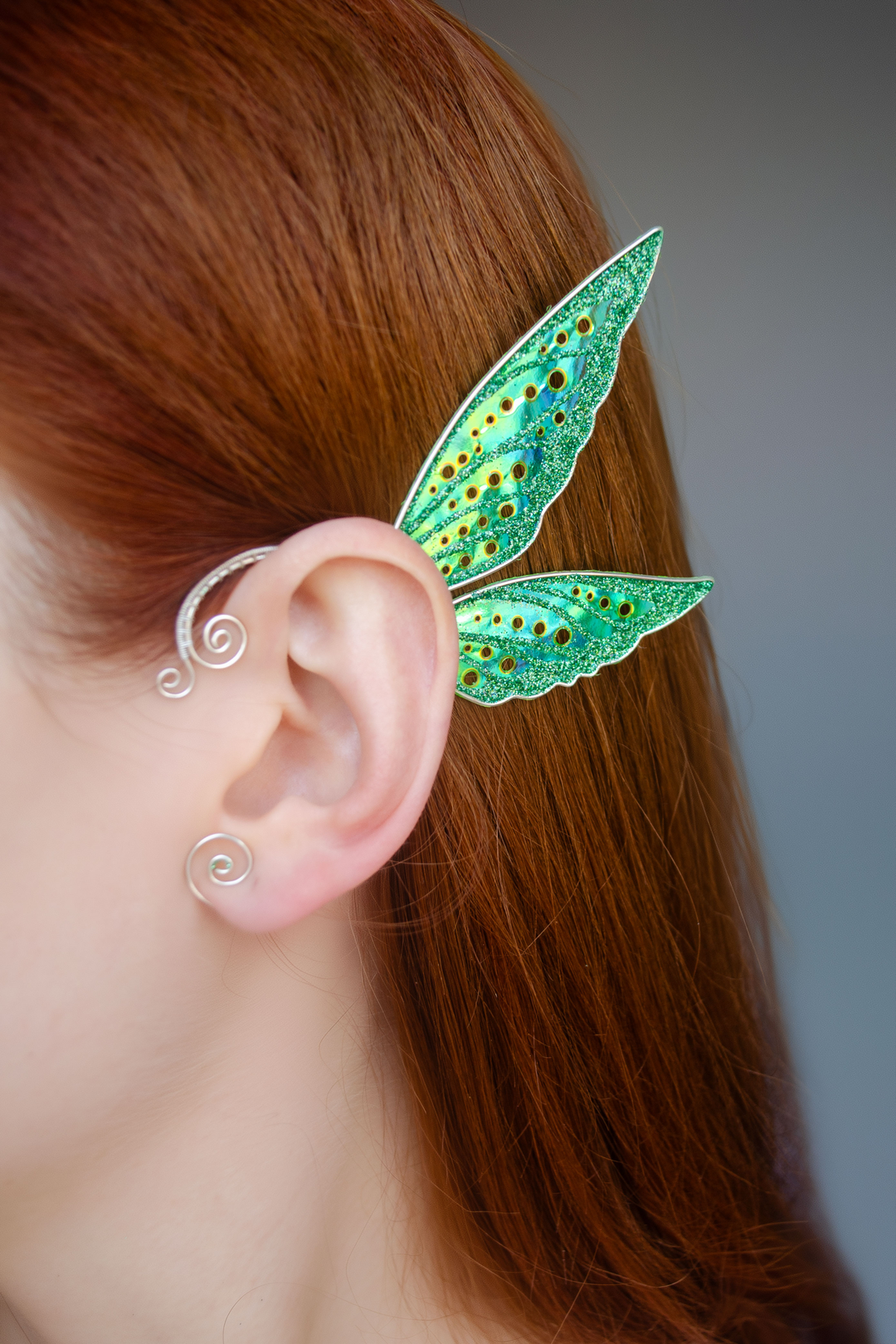 Fairy cosplay ear cuff, green, handmade, no piercing needed, fairy earring — green wing ear cuff shown on model with red hair.