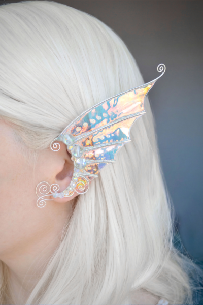 Gold and white mermaid ear cuff worn on model with white hair, handmade cosplay accessory