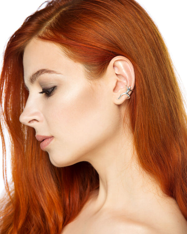 Sterling silver ear cuff shaped like a climbing man, worn on ear without piercing