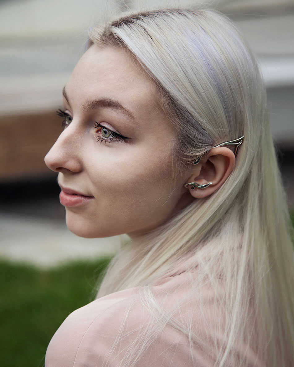 Model wearing silver elf ear cuff outdoors