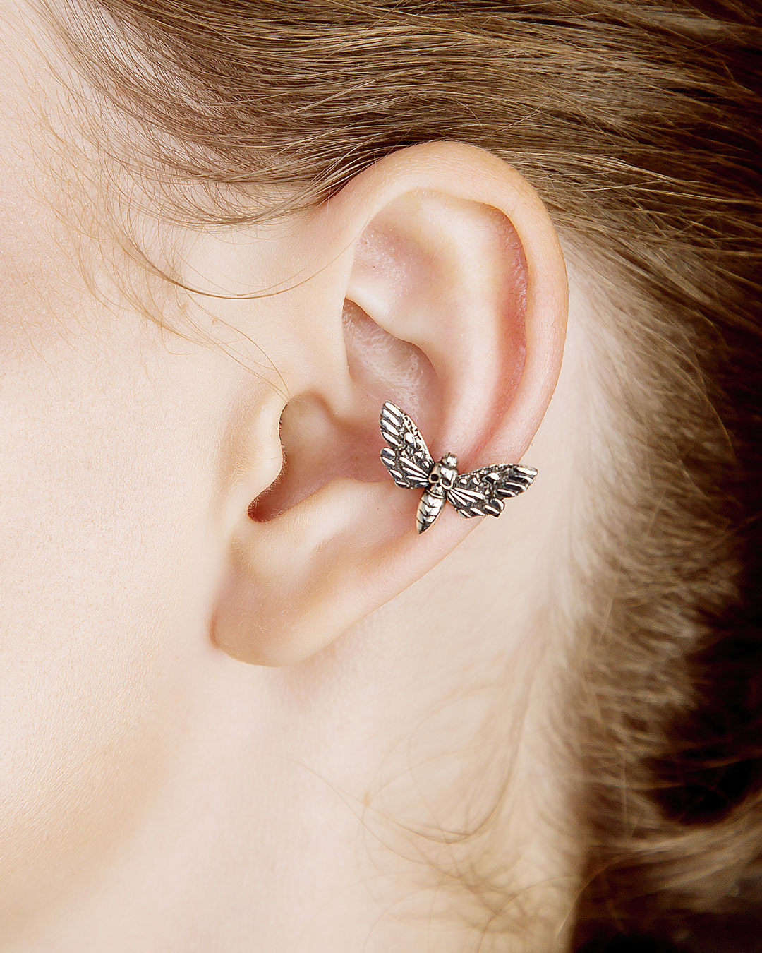 Model wearing hawk moth ear cuff, close-up