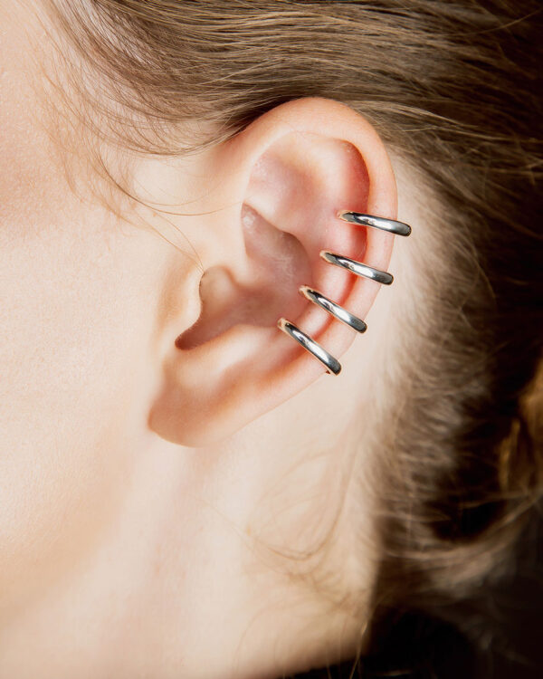 Sterling silver ear cuff with four smooth bands, worn on the ear as fake piercing, unisex design, no piercing needed