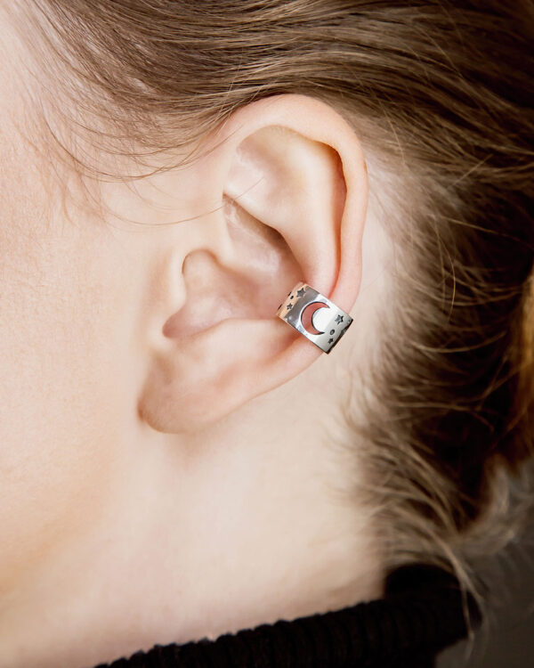 Sterling silver ear cuff with moon and stars pattern, worn on ear, oxidized finish, no piercing needed