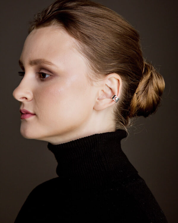 Sterling silver ear cuff with moon and stars design, shown on model, no piercing needed