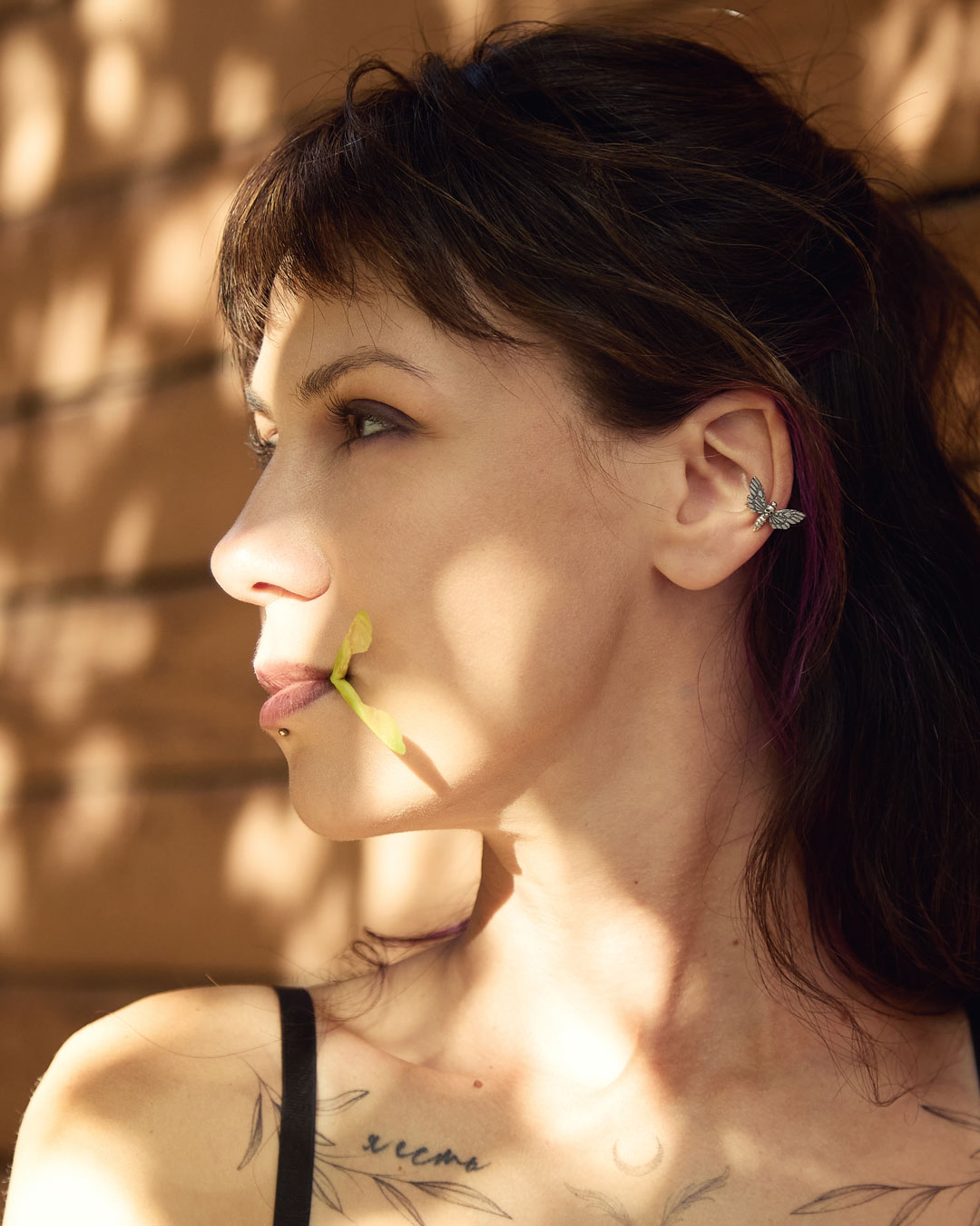 Model wearing hawk moth ear cuff in sunlight