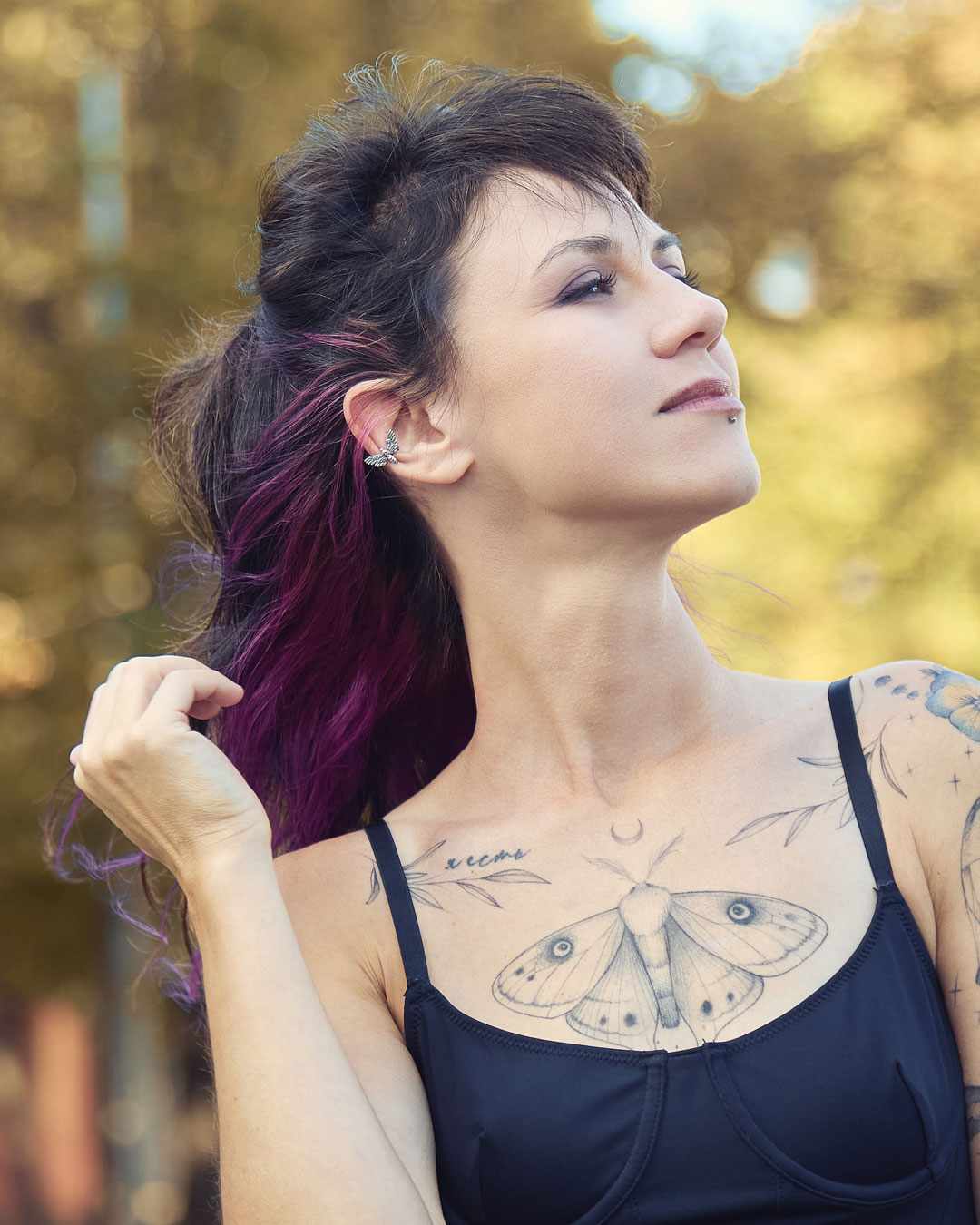 Hawk moth ear cuff on model with purple hair ends