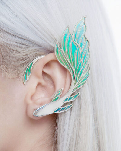 close-up of silver fish ear cuff on ear, detailed iridescent enamel tail