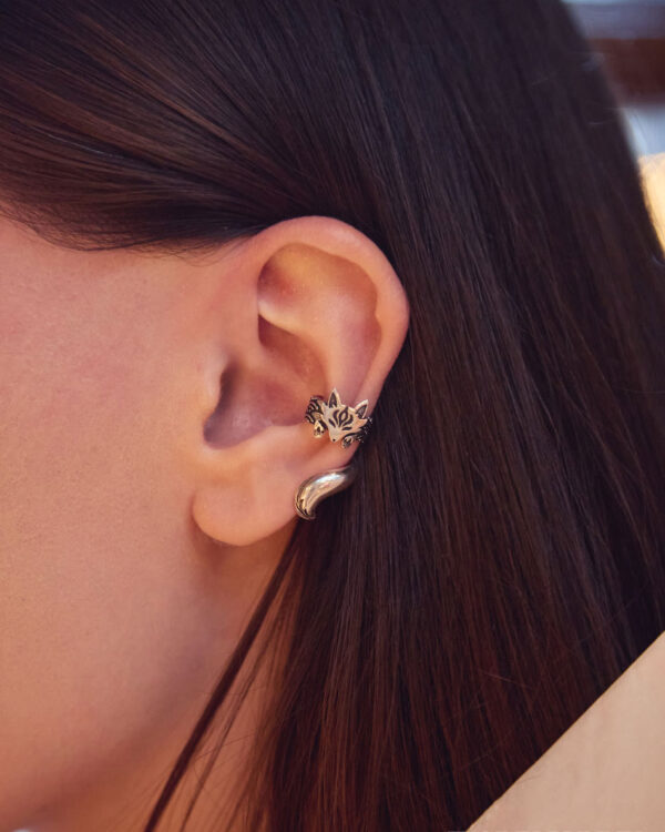Close-up of ear wearing silver fox ear cuff with dark brown hair