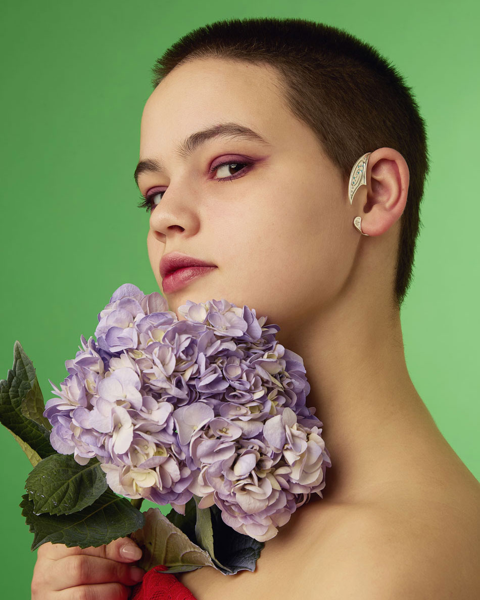 Woman wearing silver galaxy ear cuff on left ear