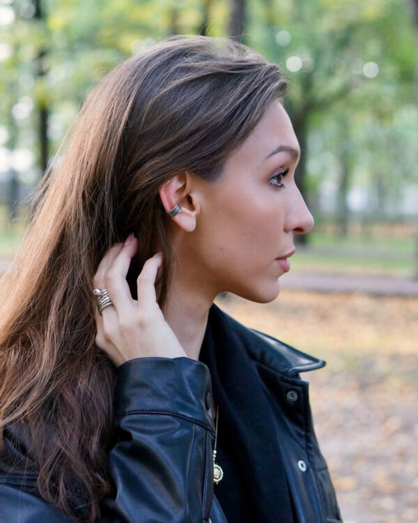 Sterling silver Dark Forest ear cuff worn by female model outdoors, side profile