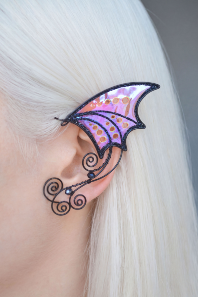 Scarlet gothic bat ear cuff worn on white-haired model, handmade no-piercing Halloween jewelry