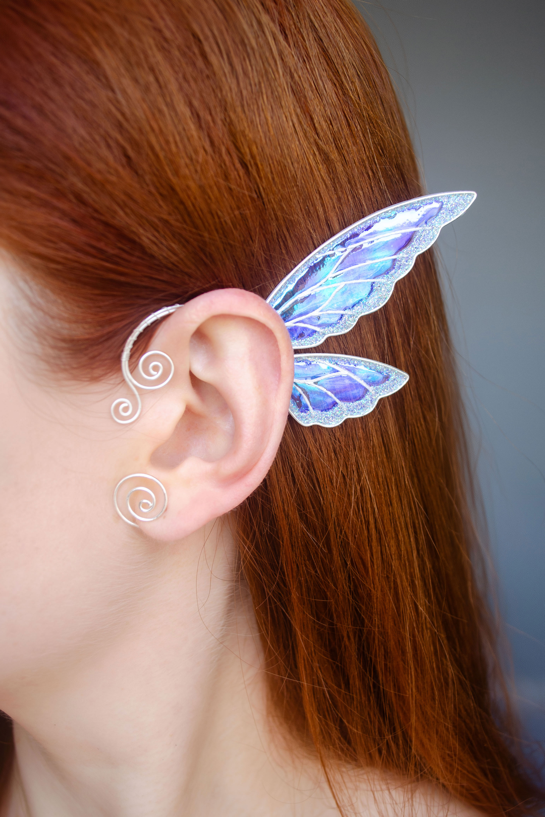 fairy wing ear cuff in white iridescent finish worn on ear, fairy cosplay accessory