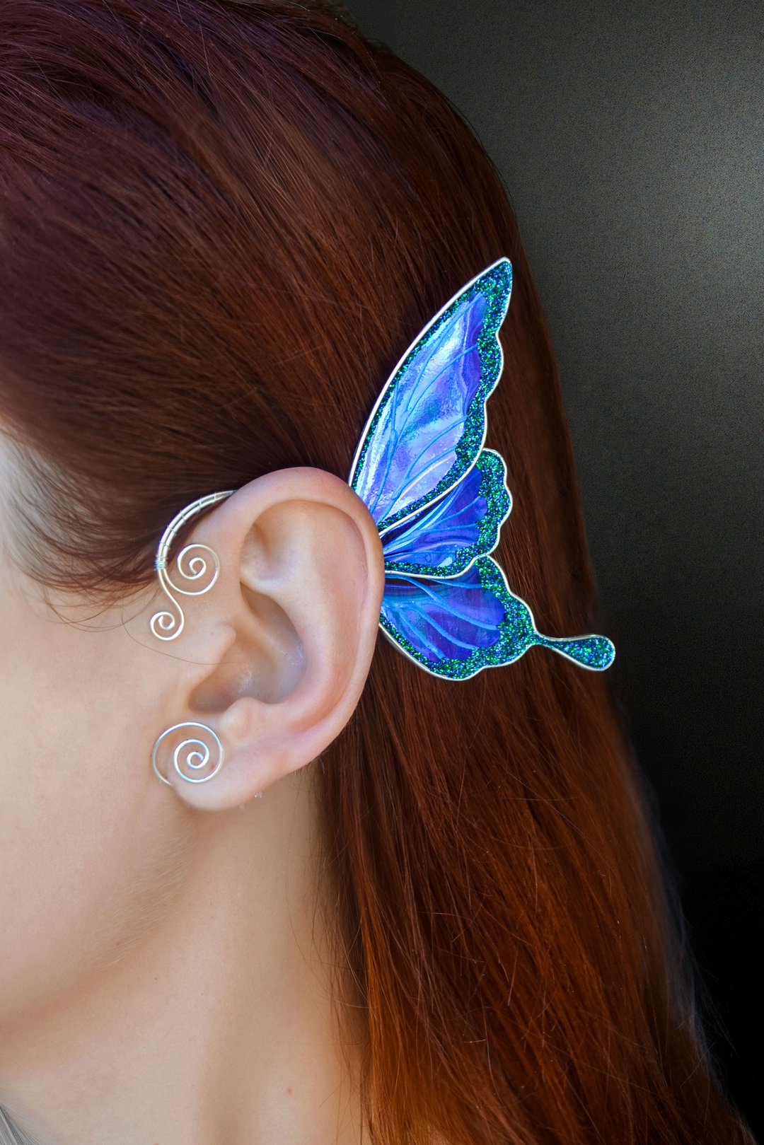 Blue iridescent fairy wing ear cuff worn on ear, no piercing needed