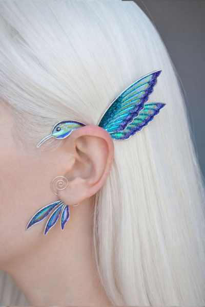 handmade hummingbird ear cuff worn on ear, white-haired model