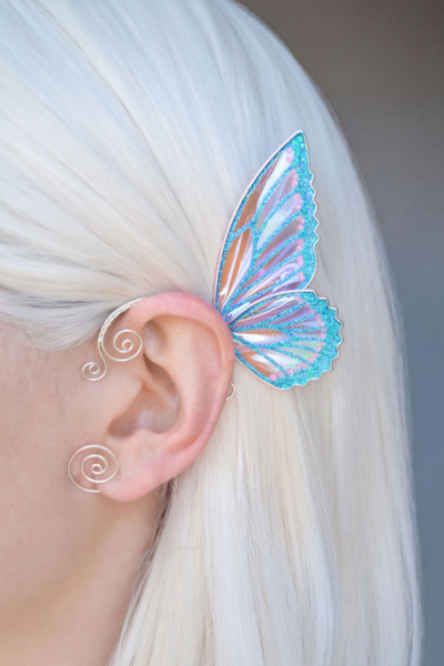 cute butterfly ear cuff in blue worn on ear, handmade no-piercing fairy cosplay earring