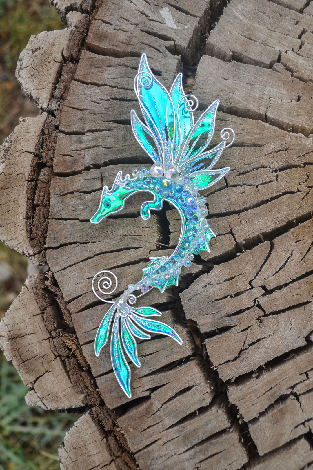 sea dragon ear cuff handmade silver fantasy jewelry on wooden background
