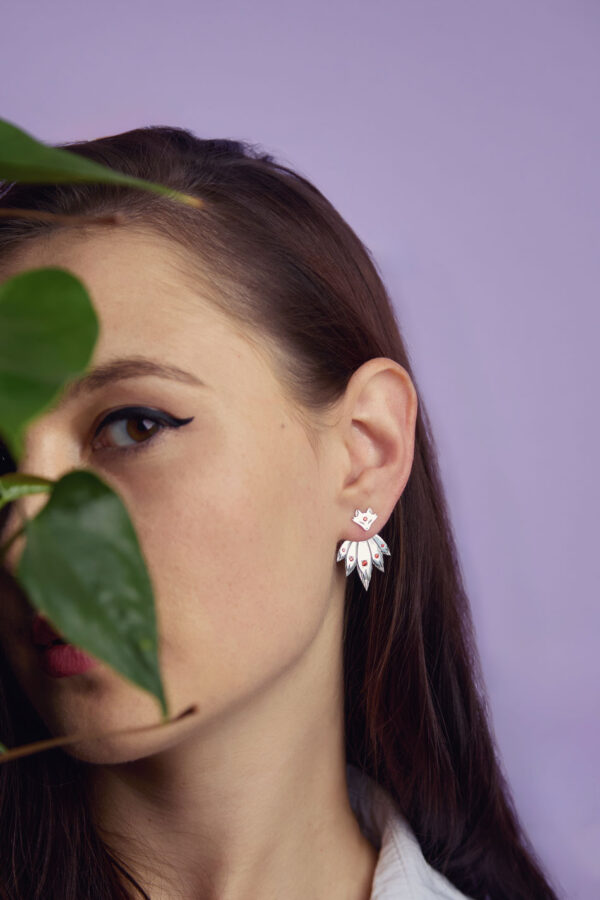 Sterling silver fox ear jackets with red cubic zirconia, worn by model with dark hair, kitsune design