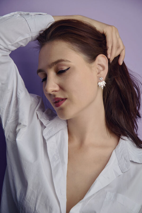 Sterling silver fox ear jackets with red cubic zirconia, worn by model in white shirt, kitsune design