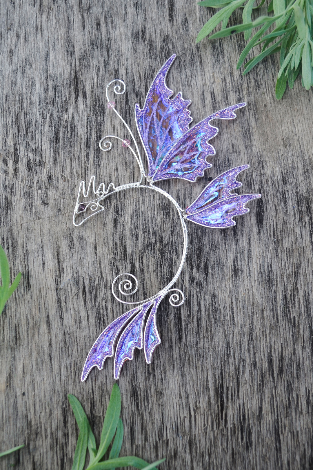 fairy dragon ear cuff on wooden background, handmade fantasy ear cuff with wing details
