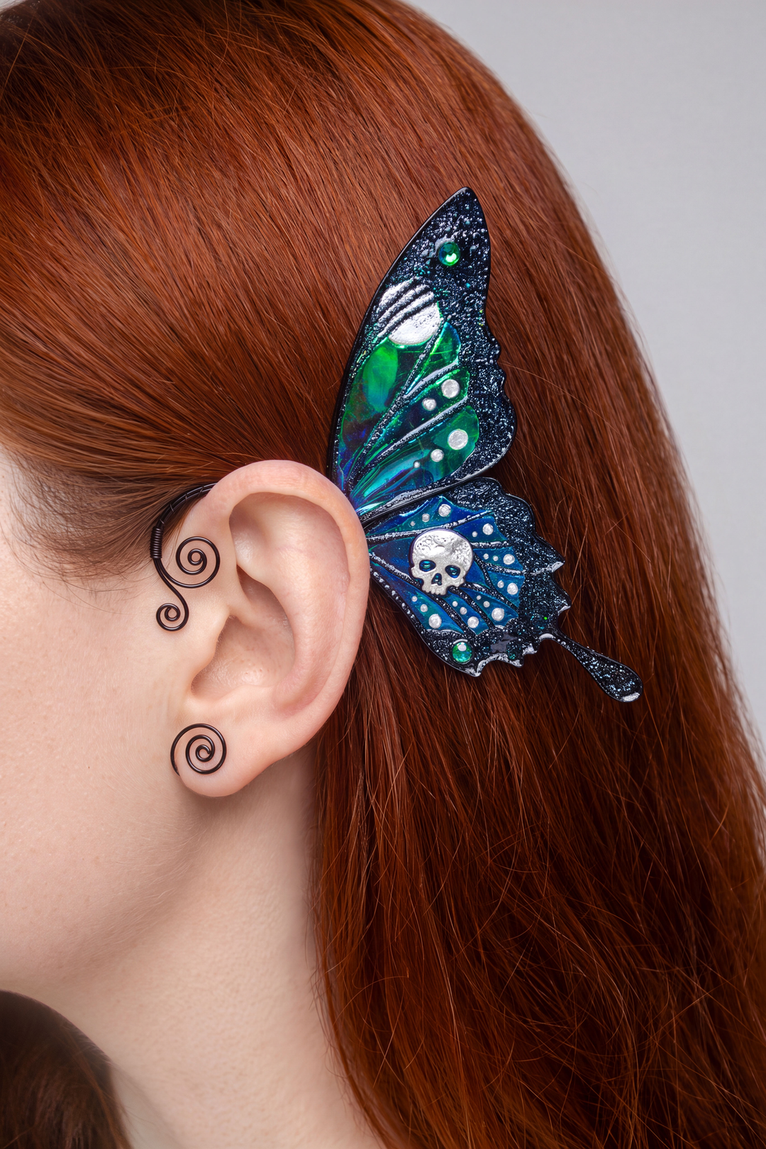 Gothic butterfly ear cuff with skull worn on red hair
