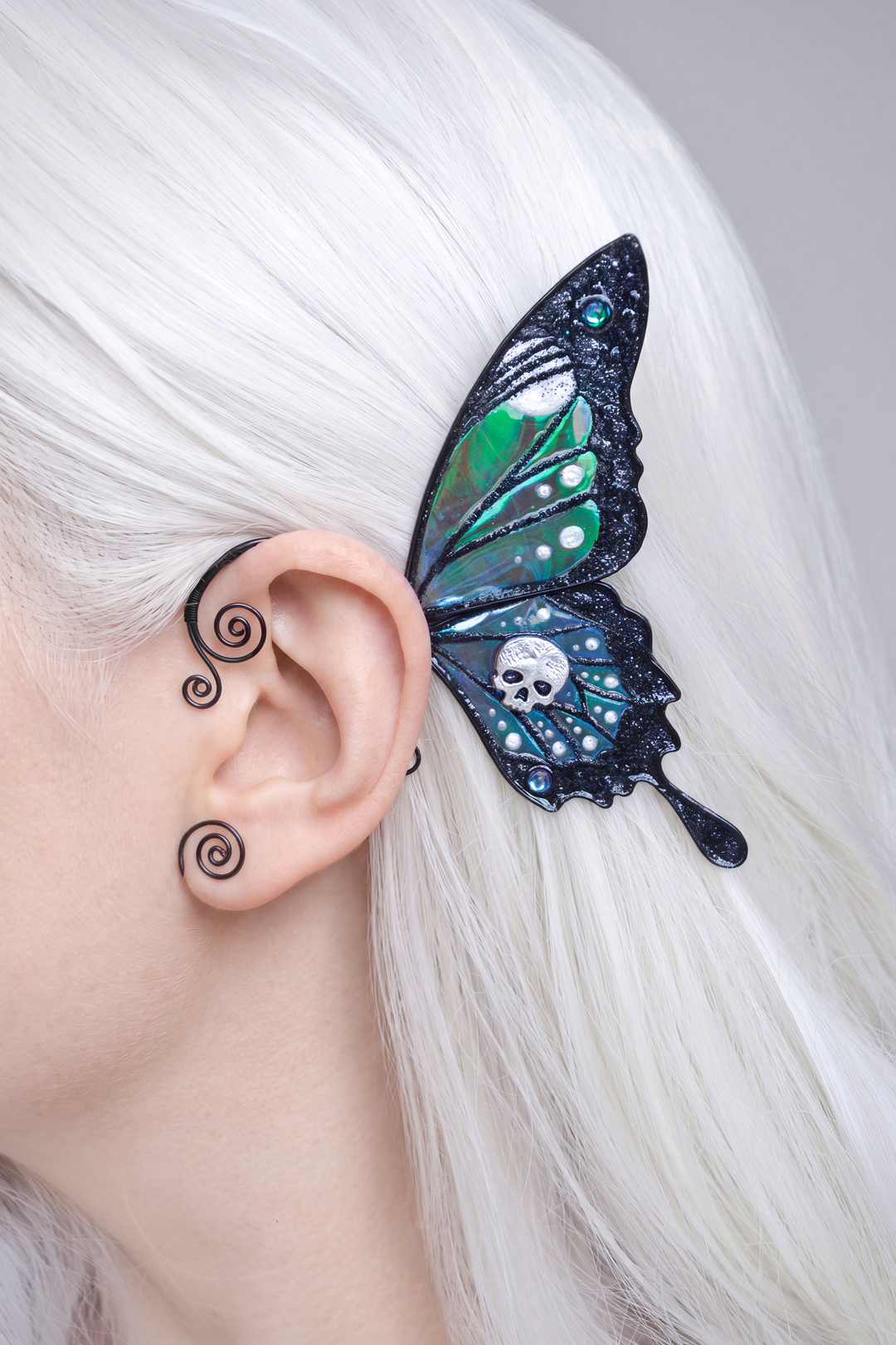 Gothic butterfly ear cuff with skull worn on blonde hair