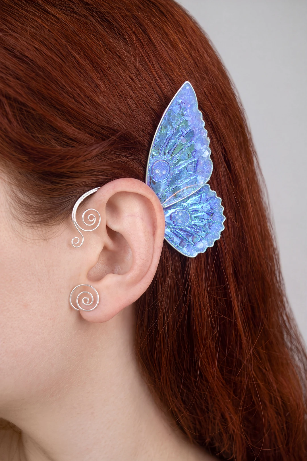Blue butterfly ear cuff with skull worn on the ear
