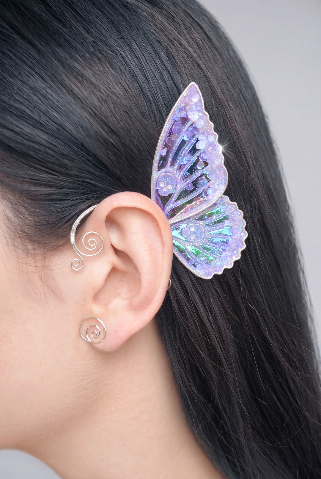 Pink butterfly ear cuff with skull worn on dark hair